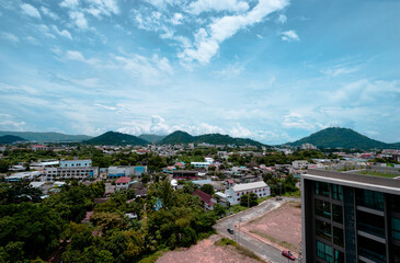 Scenic Urban View Surrounded by Rolling Hills and Clear Blue Skies