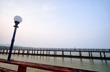 Tranquil Scenic View of a Wooden Pier Extending Over Calm Waters