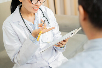 Cropped view shot of doctor and mature patient man listening to her advice during appointment