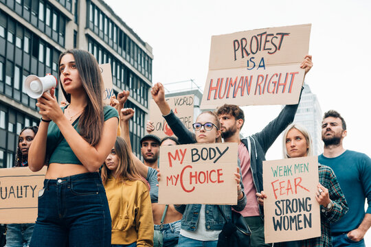 Crowd protesting for human rights, women empowerment and abortion rights holding protest signs