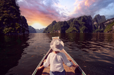 Back View of a Woman Enjoying a Serene Lake Mountain Landscape at Sunrise