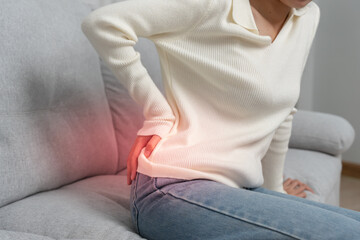 woman holding lower back while and suffer from unbearable pain health and problems, chronic back...