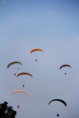 Unknown people riding bright colourful parachute. concept of extreme sport, taking adventure...