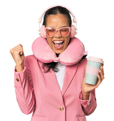 Young Filipina with chic pink attire raising fist after a victory, winner concept.