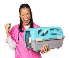 Young Filipina vet holding pet carrier raising fist after a victory, winner concept.