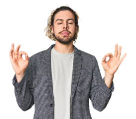 Young businessman in casual blazer relaxes after hard working day, she is performing yoga.