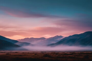 Obraz premium Serene Pastel Sunrise Over Misty Mountain Range
