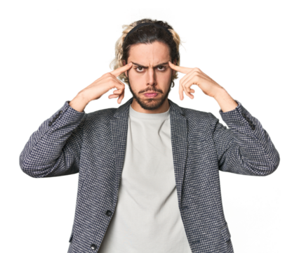 Young businessman in casual blazer focused on a task, keeping forefingers pointing head. - Powered by Adobe