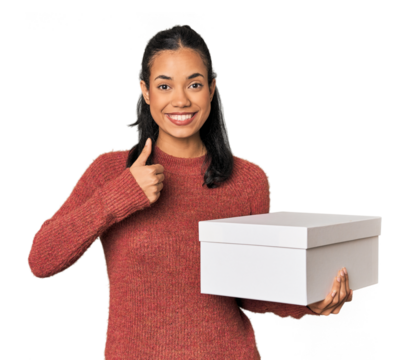 Young Filipina holding a box smiling and raising thumb up