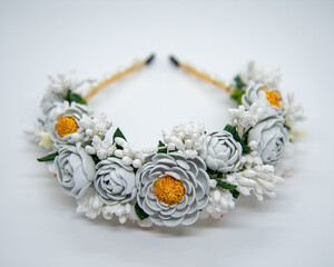 Handmade floral headband. Wild flowers made of white and yeloow foam and long plastic stamens on wires combined into bridal wreath. Wedding accessories design.