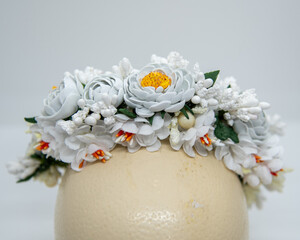 Floral wreath for the bride, close up. Eva foam white wild flowers and plastic stamens on wires combened into headband.