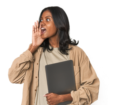 Young Indian woman studying with laptop shouting and holding palm near opened mouth.