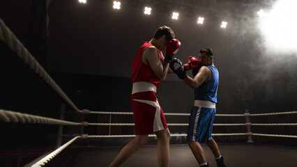 Two boxers confront each other in 3D ring illuminated by dramatic lighting and enveloped in smoke...
