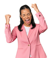 Young Filipina in pink suit raising fist after a victory, winner concept.