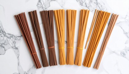 Beautiful bunch of brown and orange pasta noodles displayed in dynamic flat lay on marble