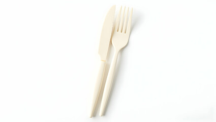 Fototapeta premium Sustainable Food Packaging Compostable knife and fork set made of cornstarch-based material, placed diagonally on white surface