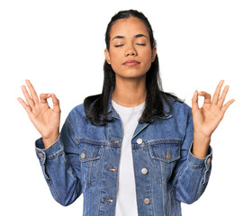 Young Filipina woman relaxes after hard working day, she is performing yoga.