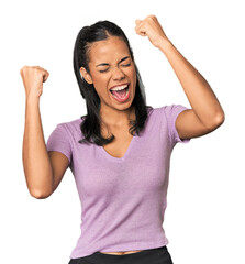 Young Filipina woman raising fist after a victory, winner concept.
