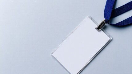 Blank ID badge with blue lanyard on a light gray background, suitable for event identification