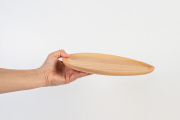 Oval wooden plate in hand on white background