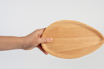 Oval wooden plate in hand on white background