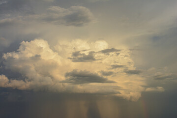 Majestic Cloudscape Illuminated by Sunlight with rainbow