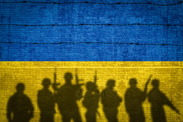 Conceptual image of war between Russia and Ukraine with shadow of soldier against wall with flags