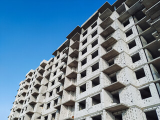 Multi-storey reinforced concrete building with walls made of light gray aerated concrete. Construction of a residential building. Concept of modern architecture. © shchus