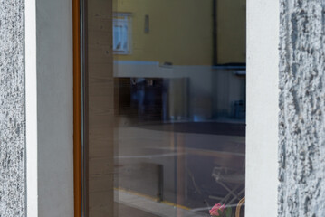 Modern store window with reflections of street and surroundings, ideal for branding mockups,...