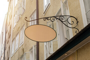 Decorative oval signage on historic building wall, suitable for boutique store visuals, café logo...