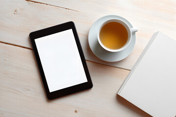 E-reader with cup of tea, cozy scene. Flat lay of digital e-reader with blank screen next to cup of tea and knitted scarf, symbolizing peaceful reading time.
