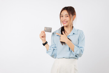 Happy young Asian woman hold credit card, pointing finger at bank card, pay with benefits and specially curated deals, smiling cheerful girl holding card in hand now, isolated studio white background