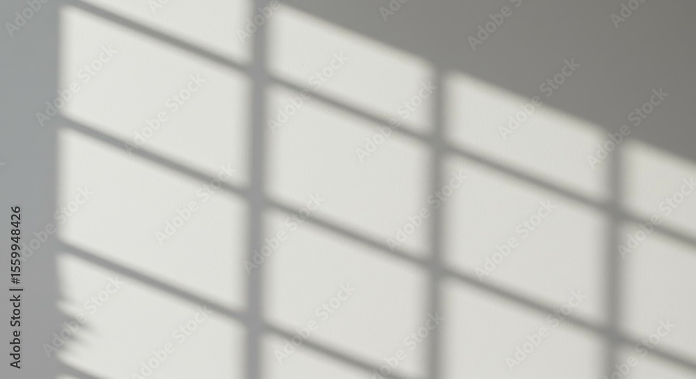 Poster window light casting abstract shadow pattern on wall