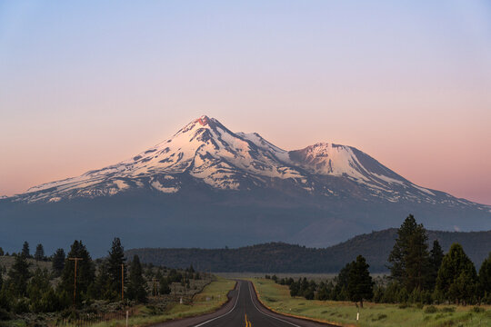 Amazing early morning view of Mount Shasta Volcano, California, USA from US highway 97, with the first rays of sunlight hitting the summit