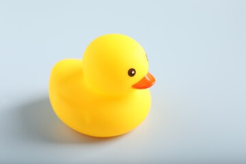 One cute rubber duck on white background, closeup. Space for text