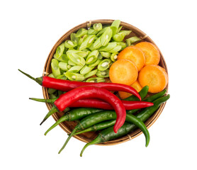 view of fresh vegetables in a wooden basket with a white isolated background