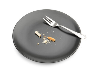 Dirty plate with bread crumbs and fork isolated on white