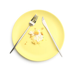Dirty plate with crumbs, cream and cutlery isolated on white, top view