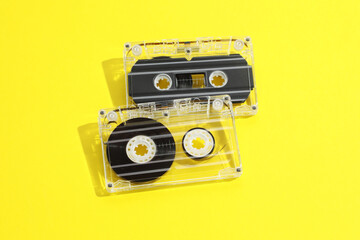 Audio cassettes with magnetic tapes on yellow background