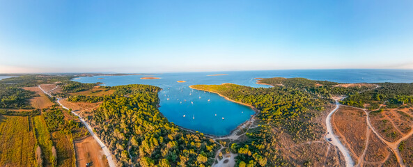 Wide panorama of Kamenjak nature park in Istria Peninsula with yachts in the picturesque lagoon at...