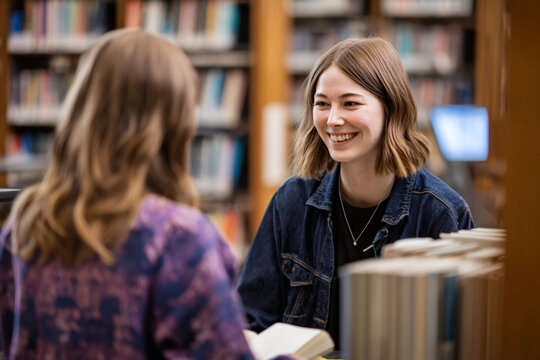 students in library reading and engaging in talks