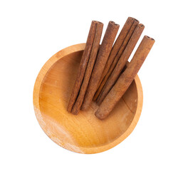 cinnamon in an isolated wooden bowl on a white background. shot with high angle view
