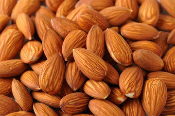 Fototapeta premium Close-up of a healthy group of raw brown almonds on a white background