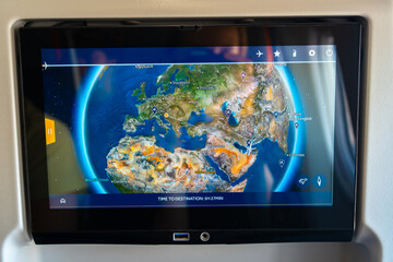 Close-up view of an airplane screen showing the in-flight map with the current route across Europe...
