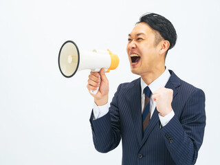 Middle-aged male business person calling out with a loudspeaker