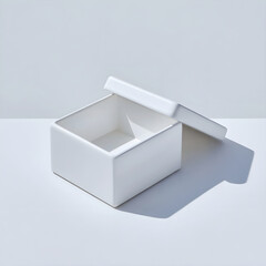 Minimalist white ceramic square box with open lid and dramatic shadow