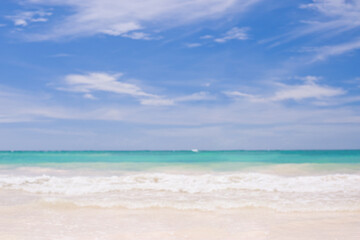 Tropical Beach Featuring Gentle Waves and Pristine Clear Blue Water. Soft focus background.