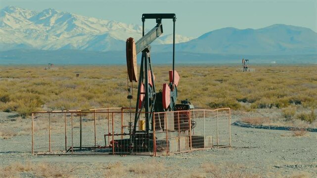 Remote oil field in Argentina overlooking Andes mountain range, oil industry facilities