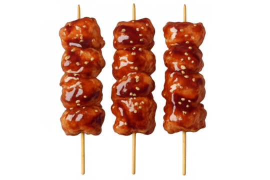 Three chicken meatballs skewers covered in teriyaki sauce on transparent background
