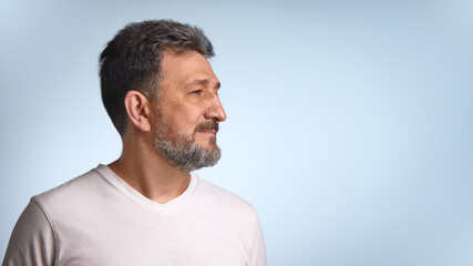 Medical awareness. Mature Caucasian man with a beard gazes thoughtfully to the side against a soft...